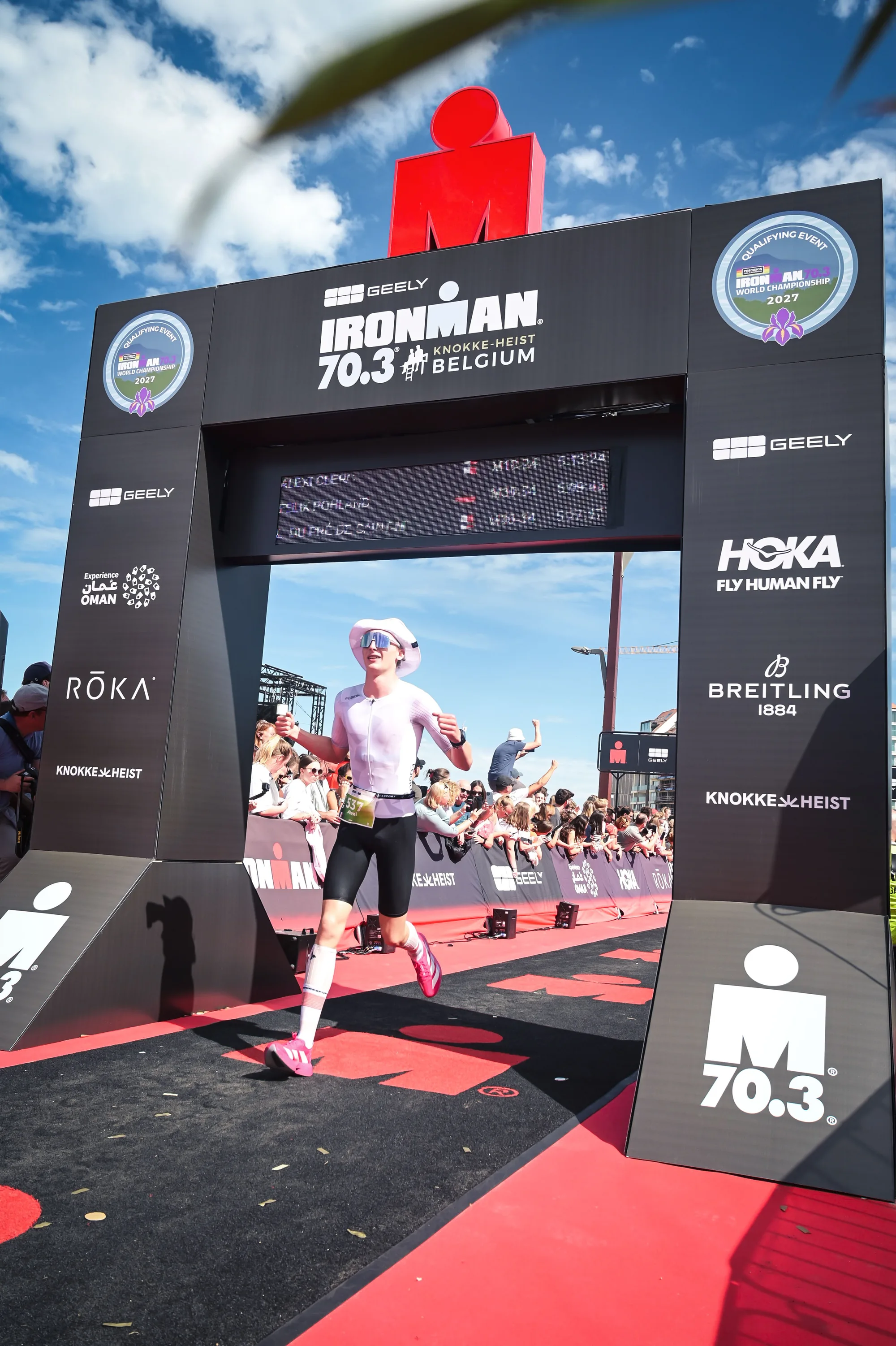 Crossing the finish line of IRONMAN 70.3 Knokke-Heist.
